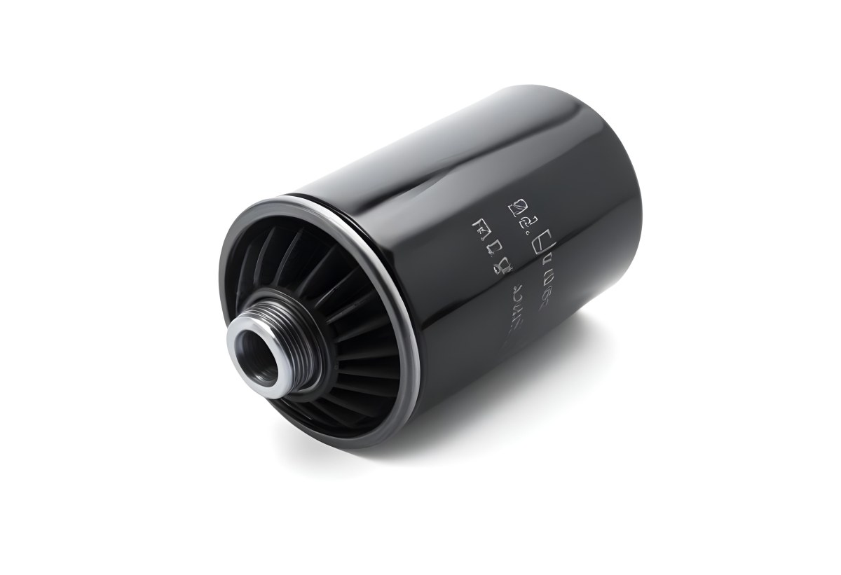 A Black Oil Filter With A Black Threaded Insert Lying On A Black Surface With A Slight Shadow Showcasing Its Cylindrical Shape And Construction 6 F571