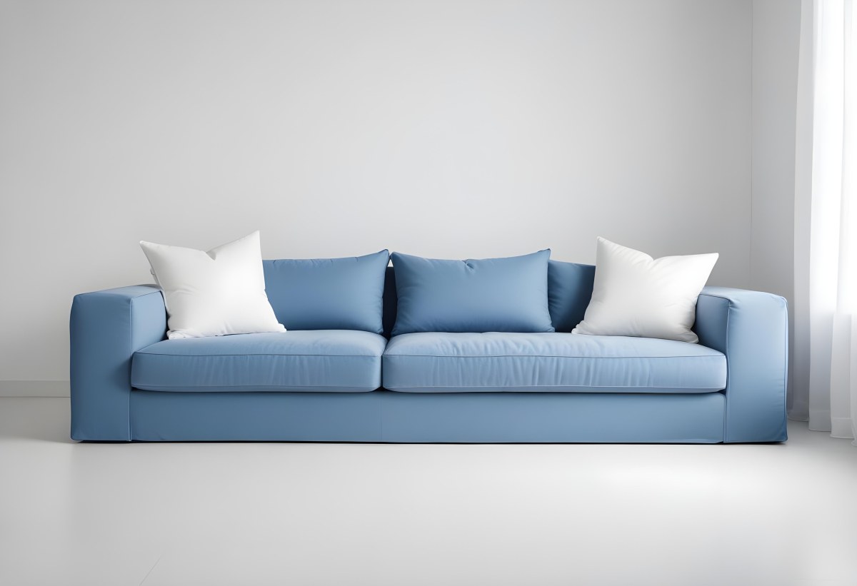A Blue Sofa With Two Pillows One White And One White In A White Background 9 5ae1