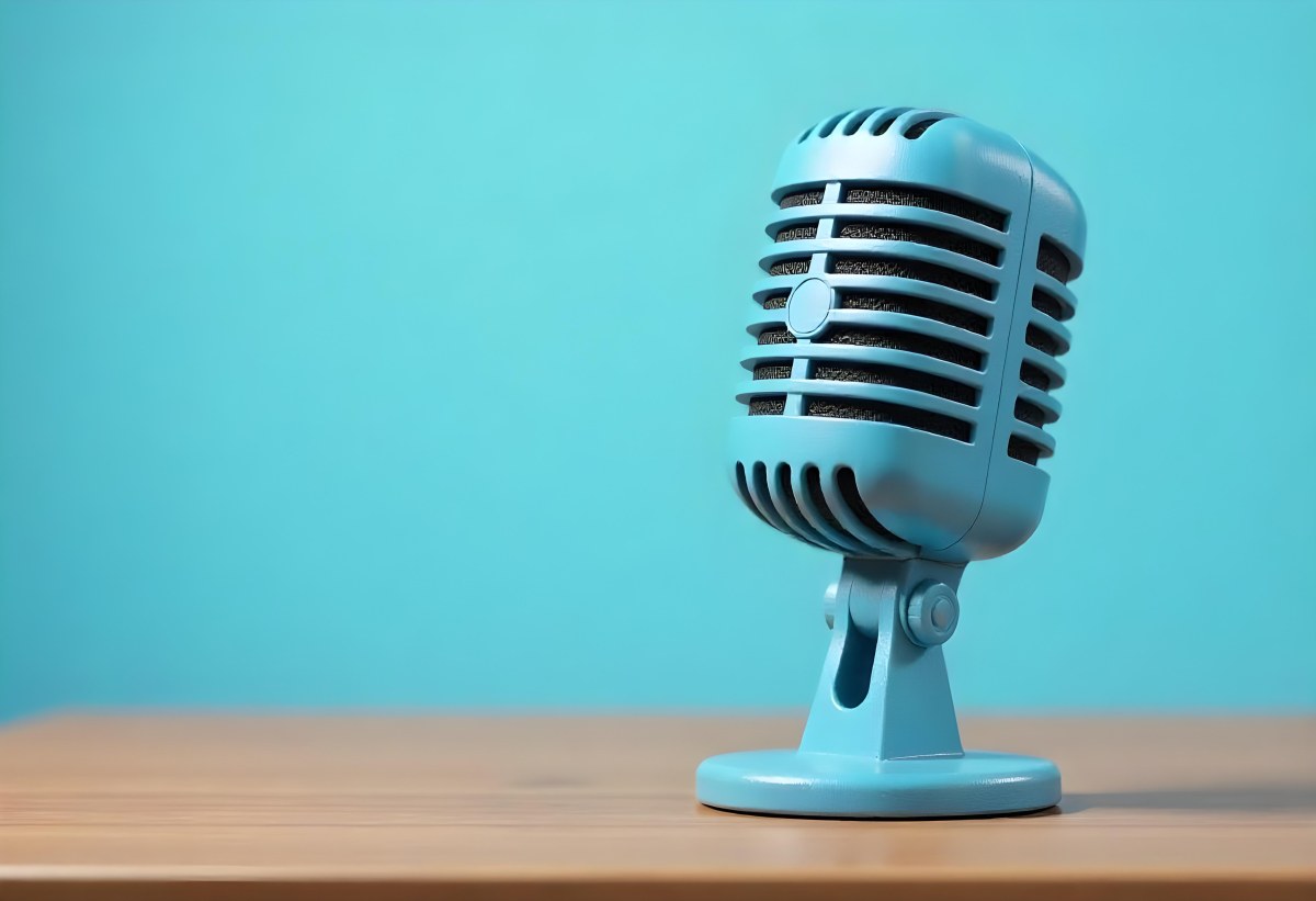 A Blue Vintage Microphone On A Wooden Table The Background Is A Solid Light Blue Color The Microphone Is Slightly Angled To The Left 15 F3e1