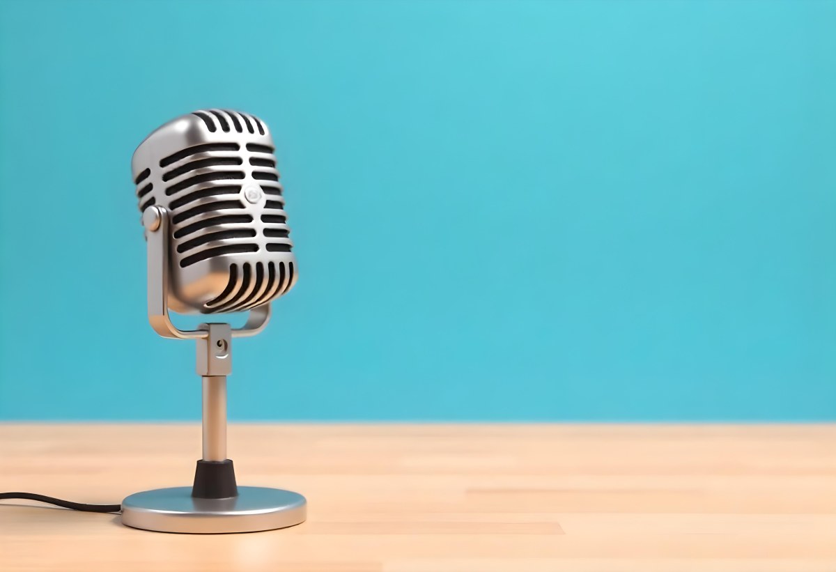 A Blue Vintage Microphone On A Wooden Table The Background Is A Solid Light Blue Color The Microphone Is Slightly Angled To The Left 3 6159