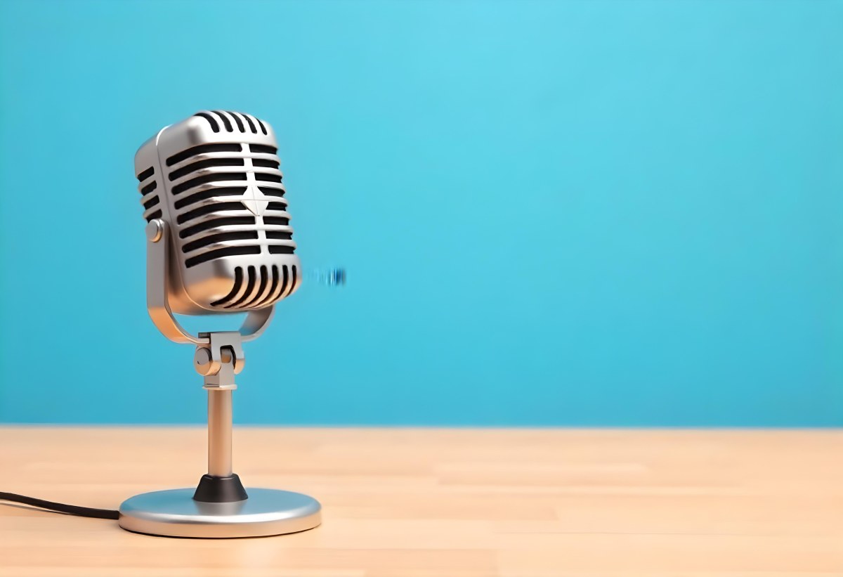A Blue Vintage Microphone On A Wooden Table The Background Is A Solid Light Blue Color The Microphone Is Slightly Angled To The Left 4 B290