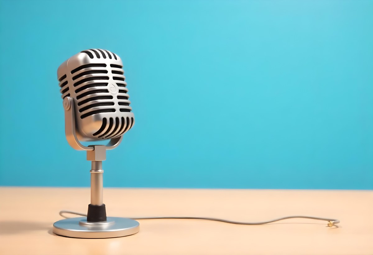 A Blue Vintage Microphone On A Wooden Table The Background Is A Solid Light Blue Color The Microphone Is Slightly Angled To The Left 5 66bb