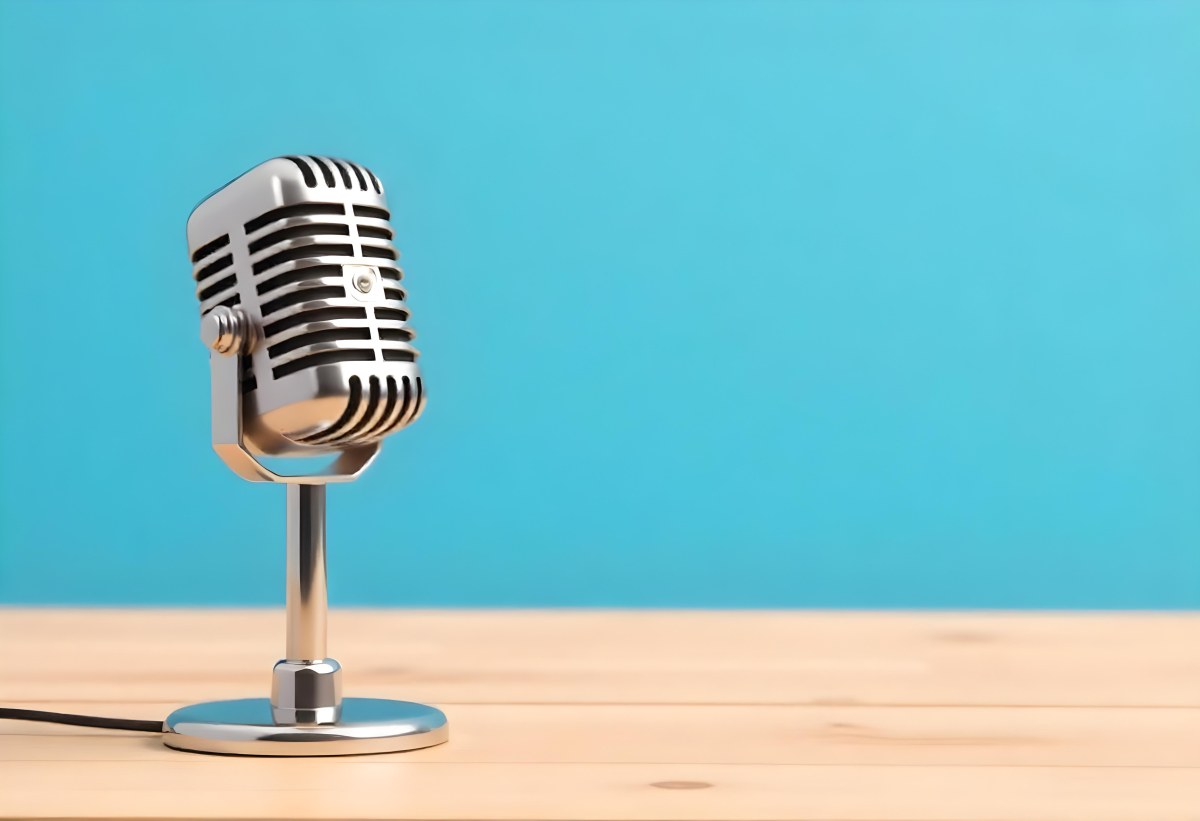 A Blue Vintage Microphone On A Wooden Table The Background Is A Solid Light Blue Color The Microphone Is Slightly Angled To The Left 6 4c93