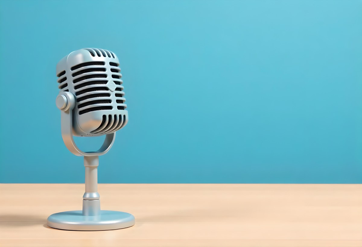 A Blue Vintage Microphone On A Wooden Table The Background Is A Solid Light Blue Color The Microphone Is Slightly Angled To The Left 8 E51f