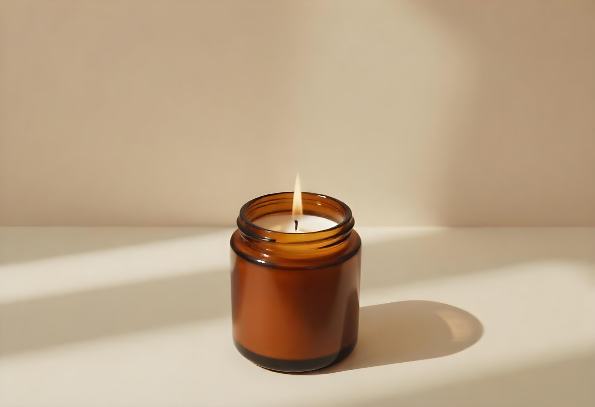A Brown Glass Jar Candle With A Flickering Flame Casting Soft Shadows On A Neutral Surface Minimalist Aesthetic Warm Lighting Simple Composition Cozy Atmosphere 4 8388
