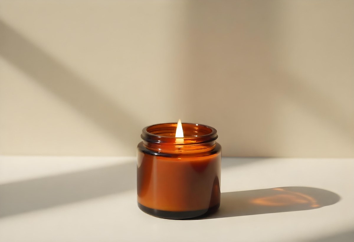 A Brown Glass Jar Candle With A Flickering Flame Casting Soft Shadows On A Neutral Surface Minimalist Aesthetic Warm Lighting Simple Composition Cozy Atmosphere 6 94c0