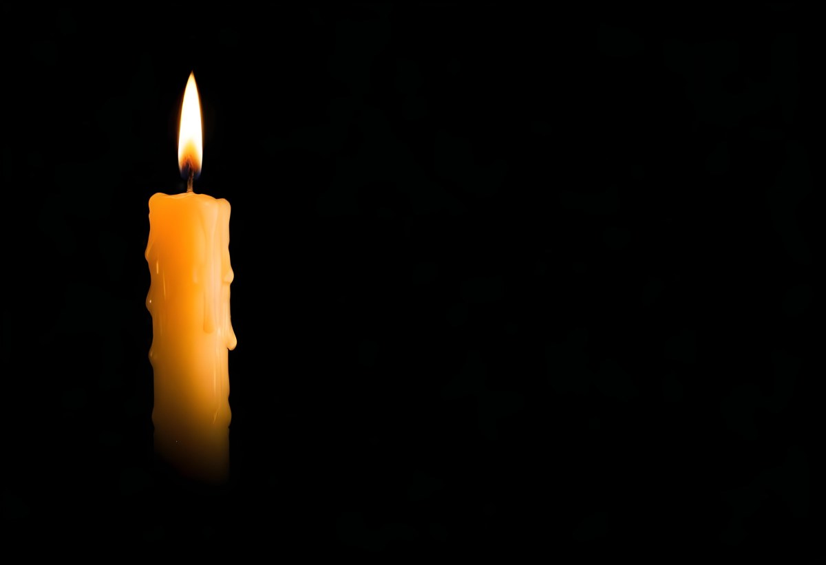 A Burning Candle With A Bright Flame The Wax Is Dripping Down The Side Casting A Warm Glow In A Dark Room 5 C063