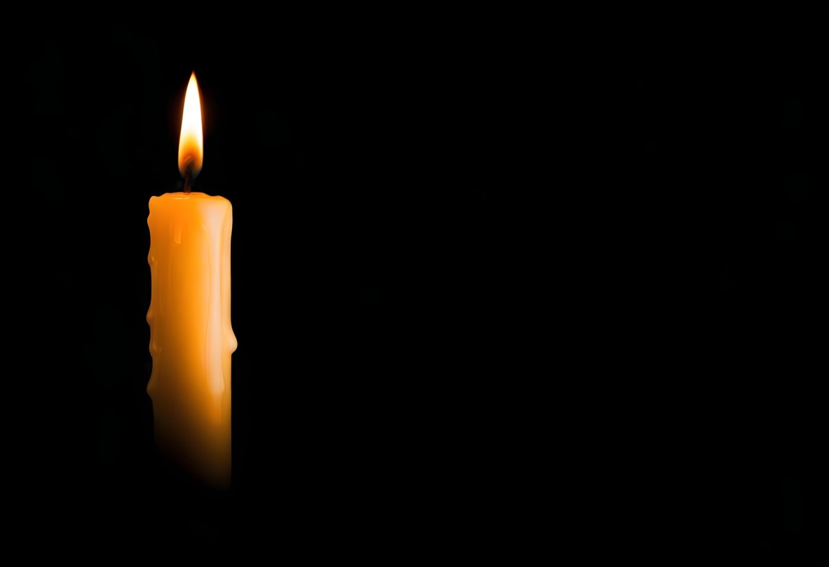 A Burning Candle With A Bright Flame The Wax Is Dripping Down The Side Casting A Warm Glow In A Dark Room 9 D51e