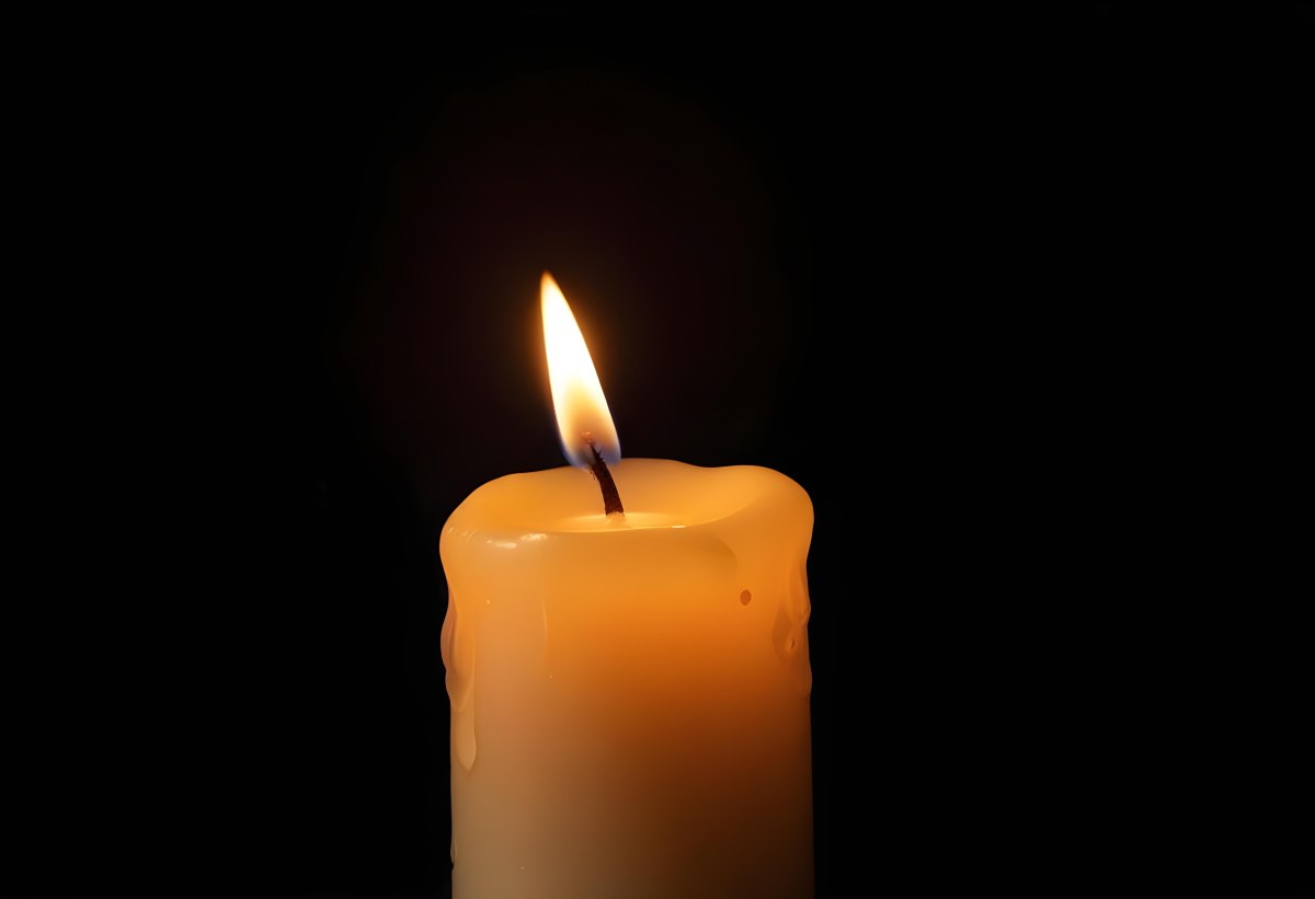 A Candle With A Bright Flame Casting A Warm Glow In The Darkness Creating A Sense Of Hope And Remembrance On A Black Background 6 79da