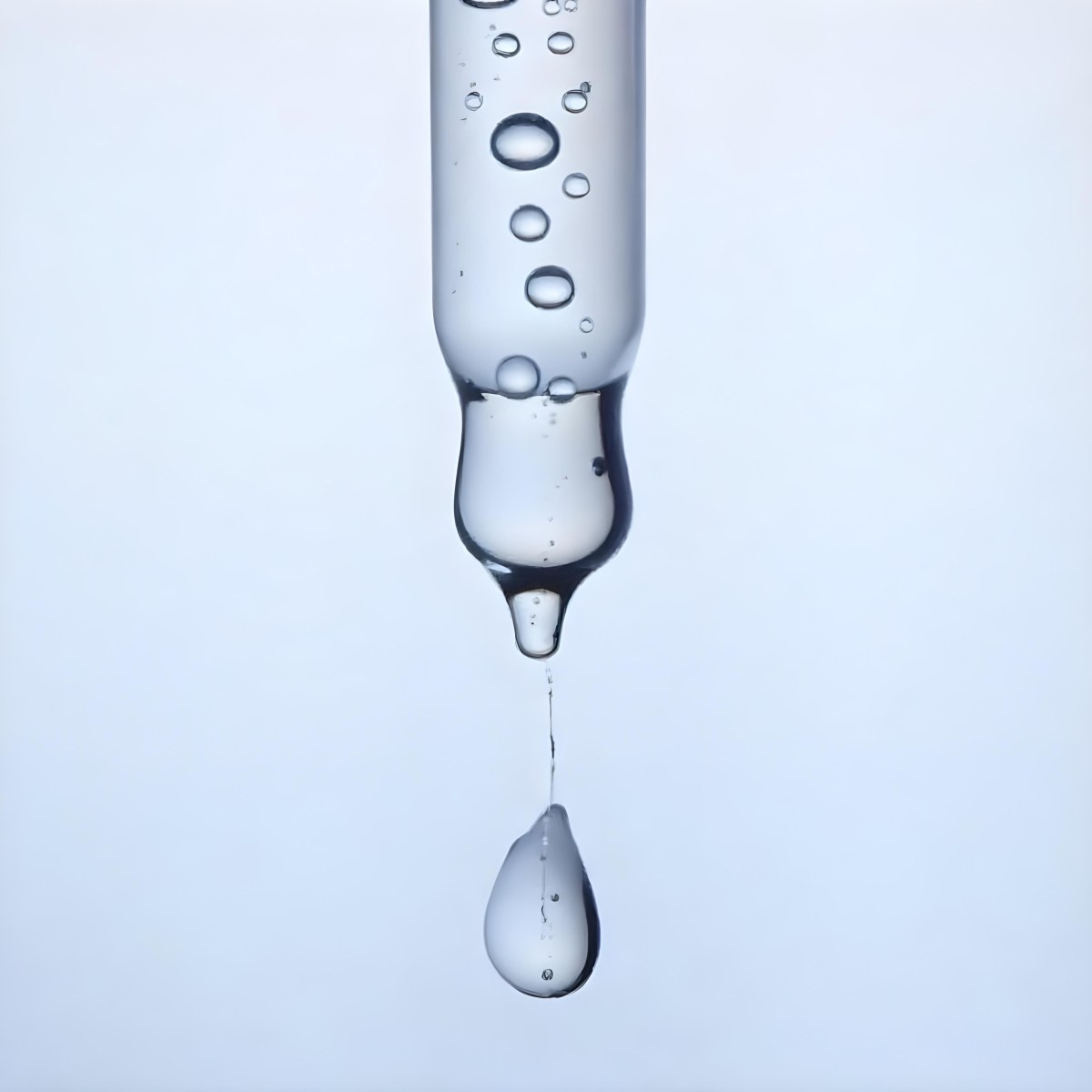 A Close Up Of A Glass Pipette With Water Droplets Against A Blue Background 5 Fbc4