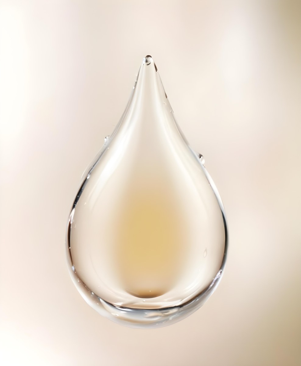 A Large Clear Glass Teardrop Shaped Object Filled With A Golden Liquid 2 4c86