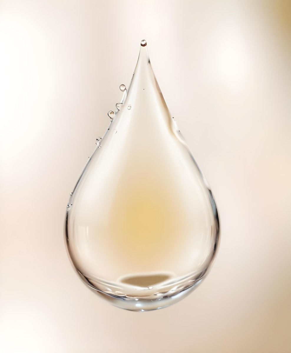 A Large Clear Glass Teardrop Shaped Object Filled With A Golden Liquid 7 0729