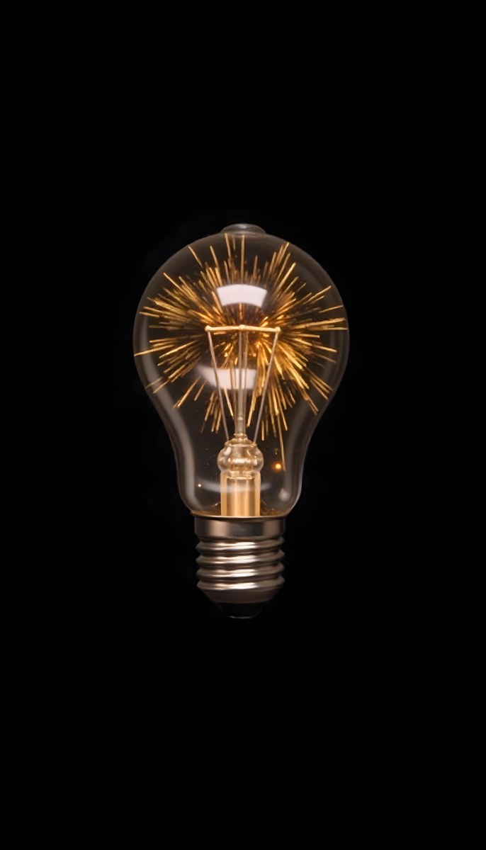 A Light Bulb With Sparks Inside The Background Is Completely Black The Light Bulb Is In The Center Of The Image 6 4ef8