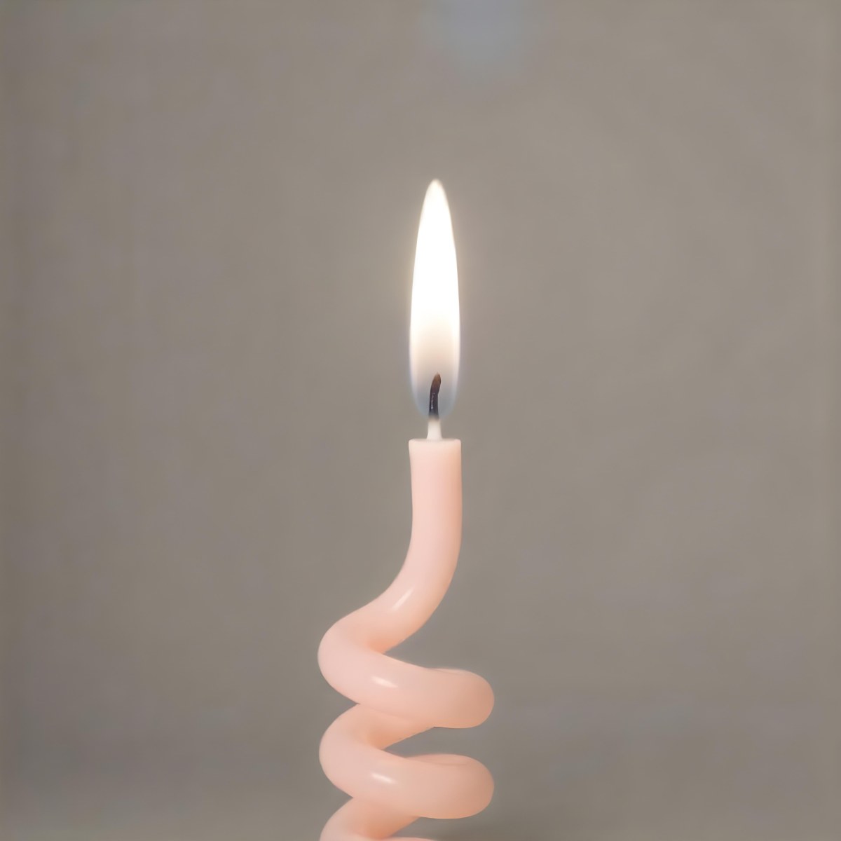 A Pink Spiral Candle With A Bright Flame On Top Casting A Bright Glow Simple Gray Background 14 016f