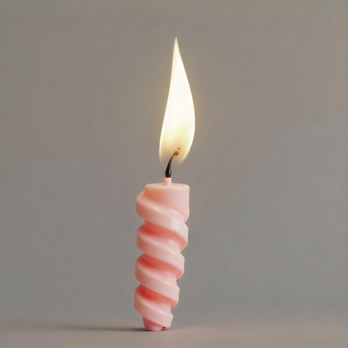 A Pink Spiral Candle With A Bright Flame On Top Casting A Bright Glow Simple Gray Background 18 74ce