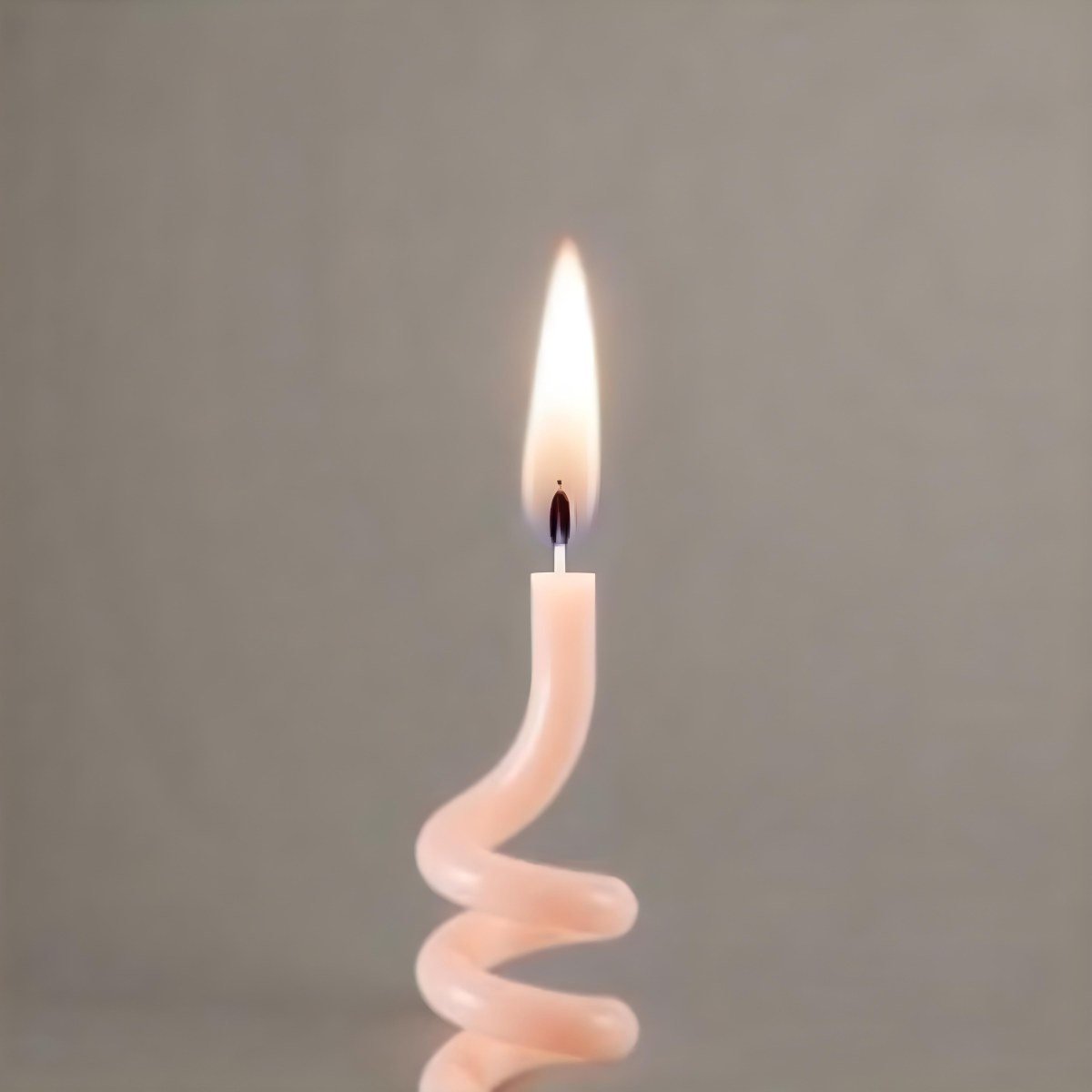A Pink Spiral Candle With A Bright Flame On Top Casting A Bright Glow Simple Gray Background 24 F7e3