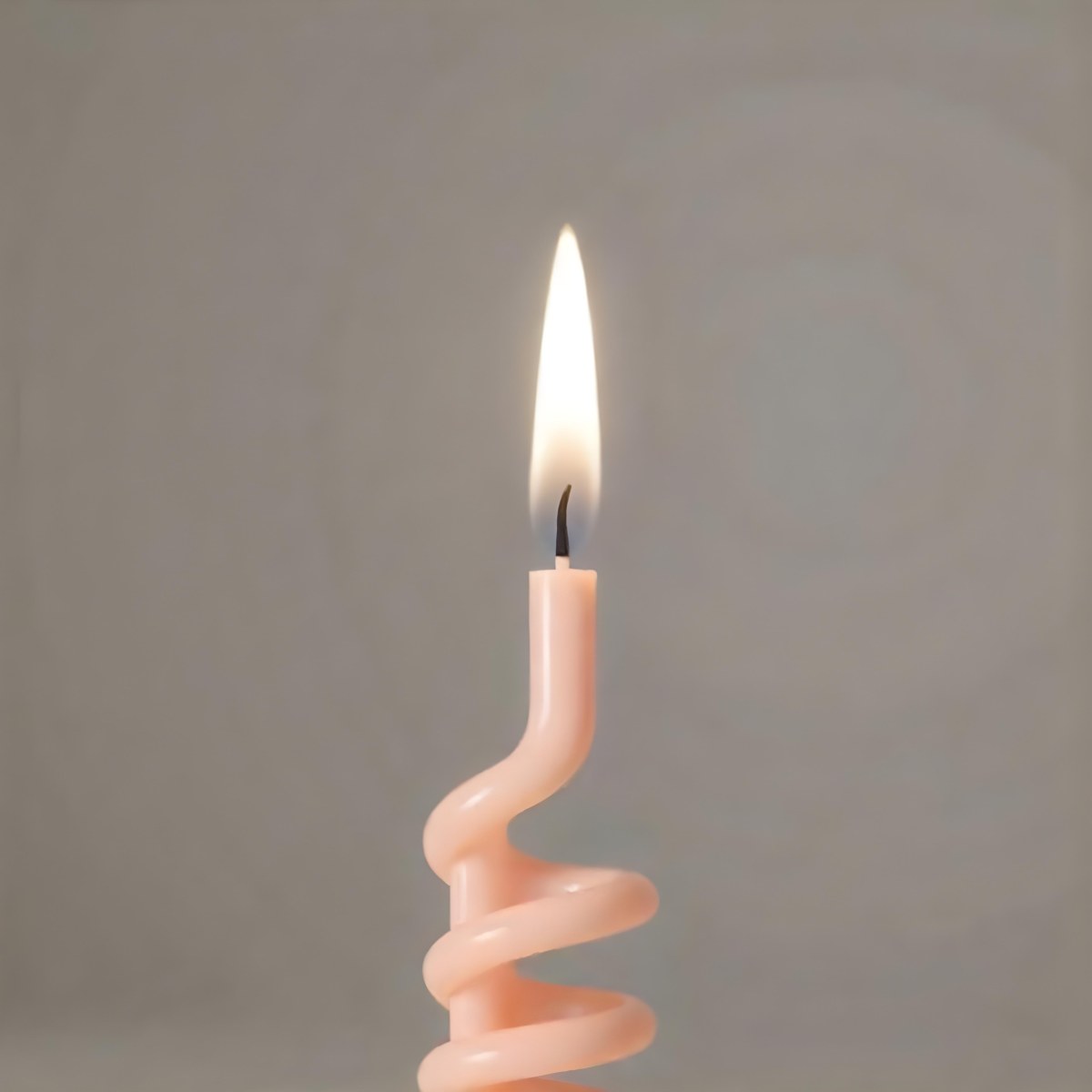 A Pink Spiral Candle With A Bright Flame On Top Casting A Bright Glow Simple Gray Background 9 Ac7e