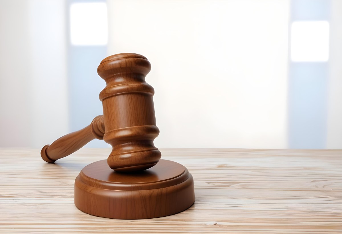 A Wooden Gavel On A Wooden Surface The Gavel Is Brown And Shiny The Background Is White And Blurred The Lighting Is Bright 7 982c