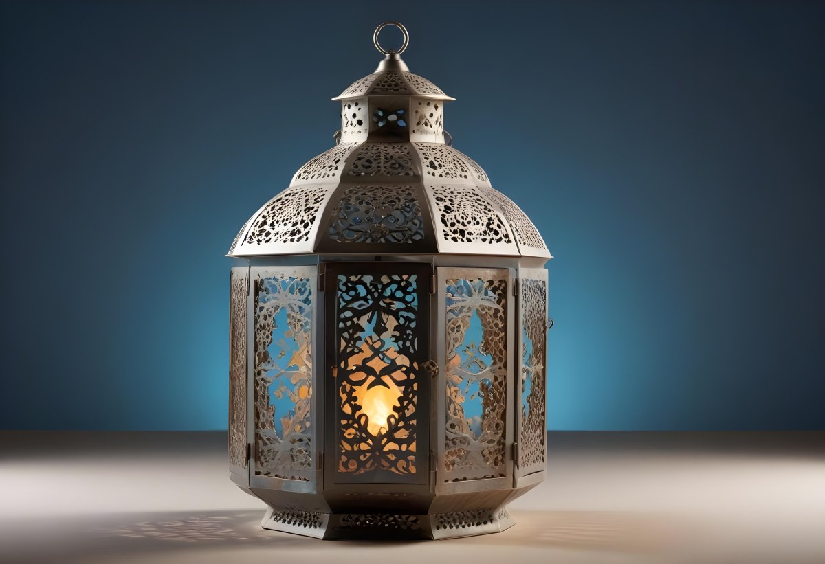 An Ornate Metal Lantern With Intricate Floral Cutouts Casting A Warm Glow On A Sandy Surface Against A Soft Gradient Blue Background 8 5a7b