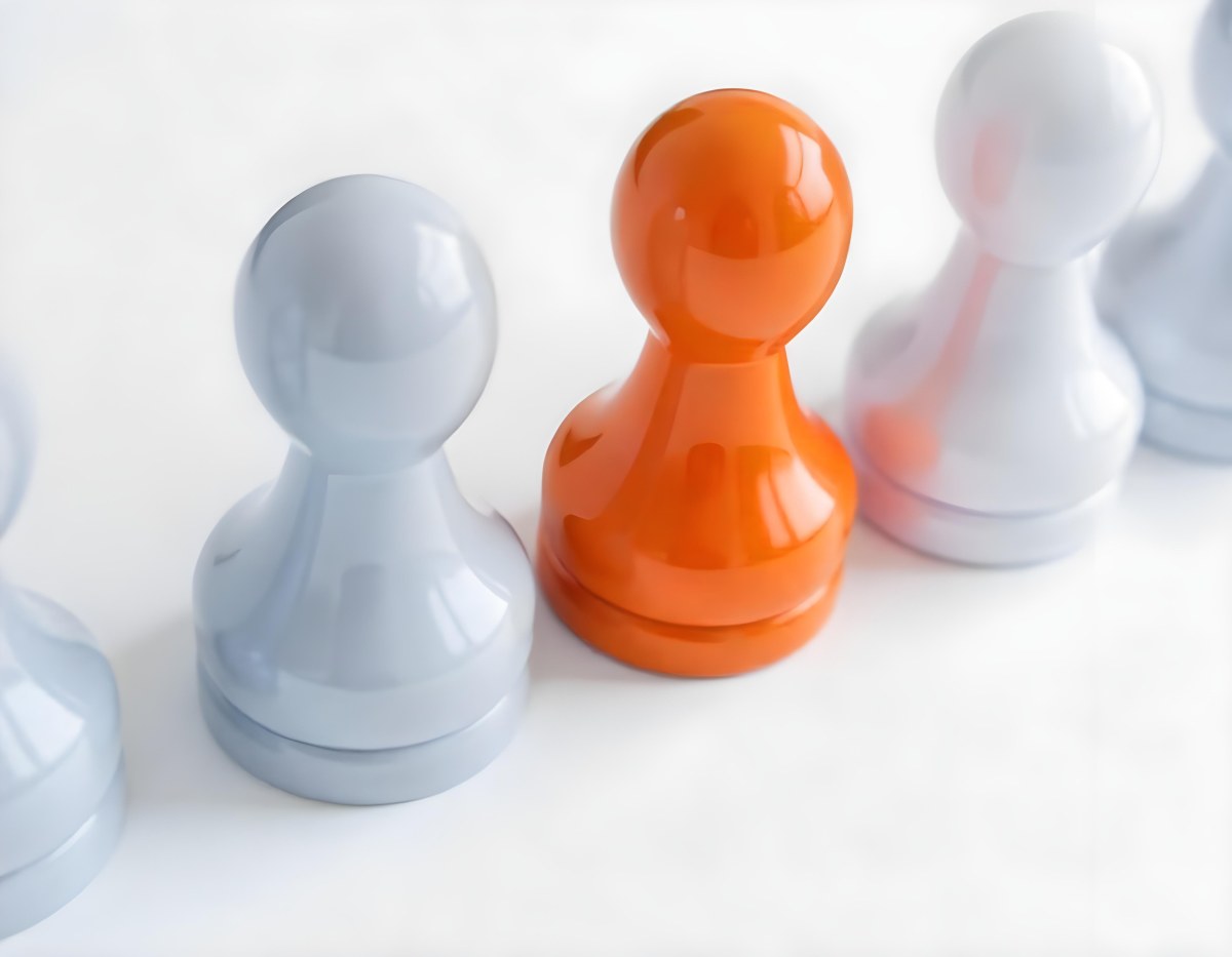 Three Game Pieces One Orange And Two Gray