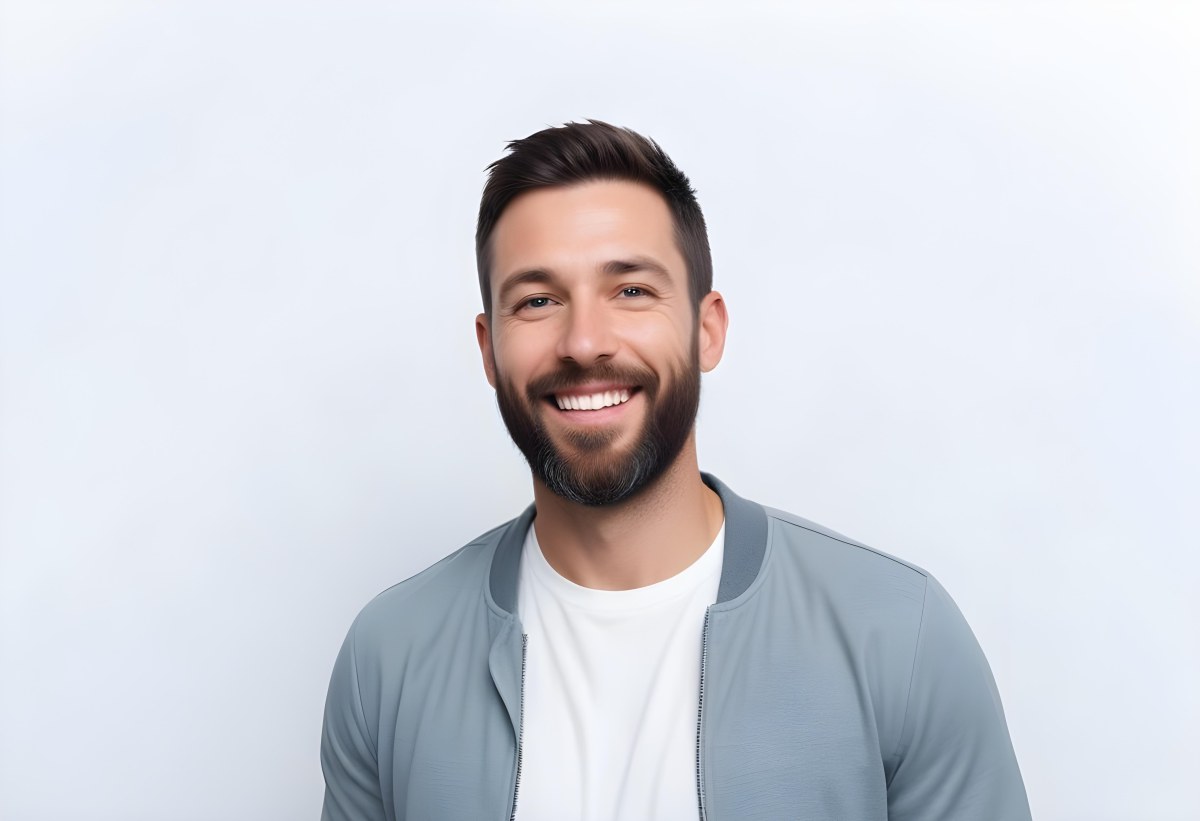 A White Man 35 Years Old With Short Dark Hair And A Beard Wearing A White T Shirt And A Gray Jacket Smiling In A White Background 5 1fdd