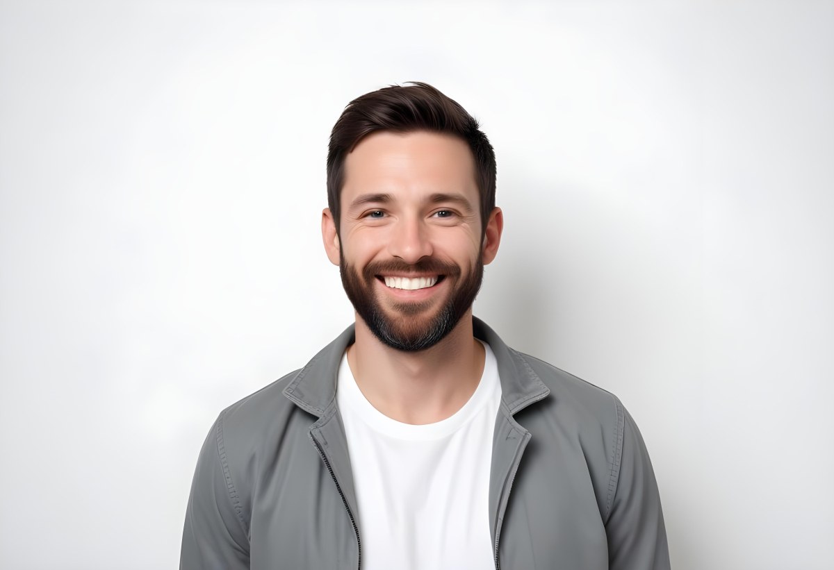 A White Man 35 Years Old With Short Dark Hair And A Beard Wearing A White T Shirt And A Gray Jacket Smiling In A White Background 6 069d