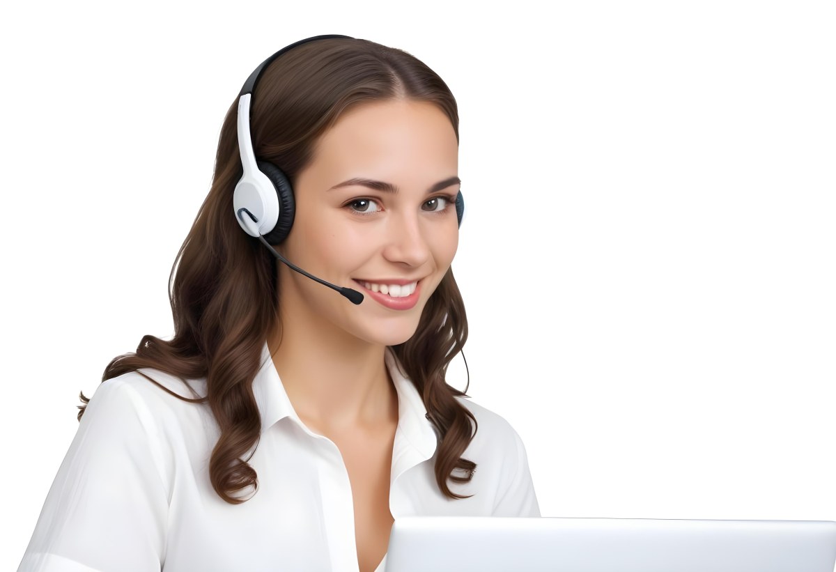 A Young Caucasian Woman Approximately 25 Years Old With Long Wavy Brown Hair Wearing A White Shirt And A Headset With A Microphone She Is Smiling And Looking Directly At The Camera With A Laptop Visible In The Foreg 39 A167