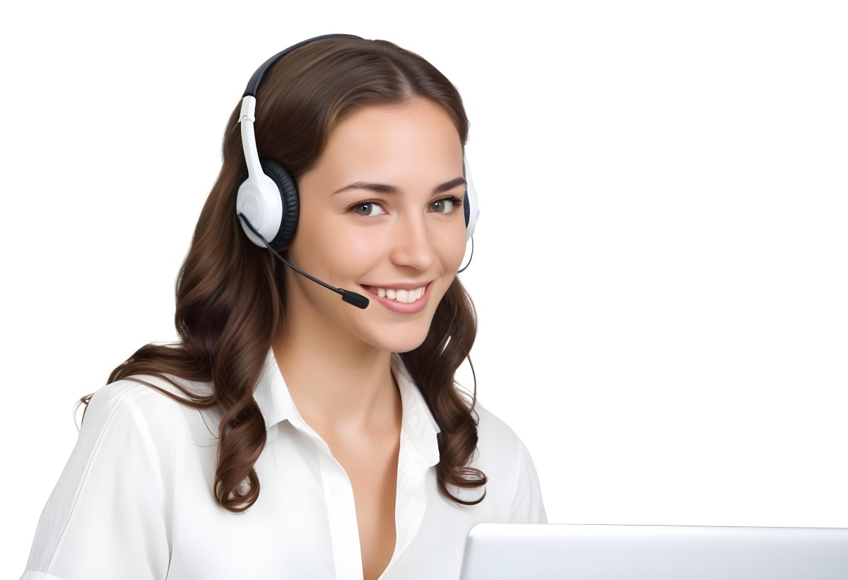 A Young Caucasian Woman Approximately 25 Years Old With Long Wavy Brown Hair Wearing A White Shirt And A Headset With A Microphone She Is Smiling And Looking Directly At The Camera With A Laptop Visible In The Foreg 42 1613
