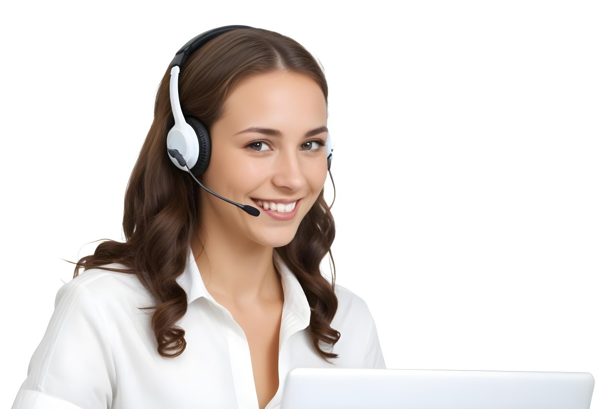 A Young Caucasian Woman Approximately 25 Years Old With Long Wavy Brown Hair Wearing A White Shirt And A Headset With A Microphone She Is Smiling And Looking Directly At The Camera With A Laptop Visible In The Foreg 43 6286