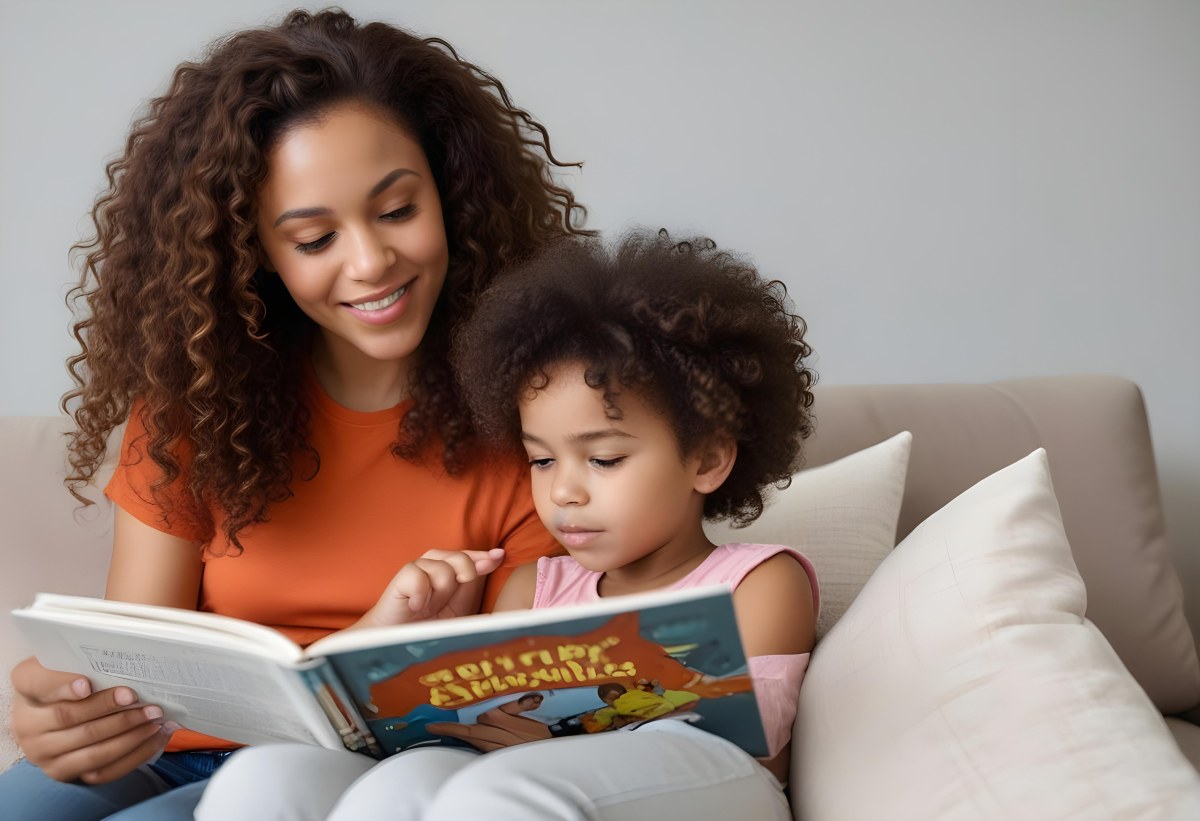 A Young Curly Haired African American Mother Reading A Book With Her Young Curly Haired African American Daughter On A Couch In A Brightly Lit Living Room 7 1beb
