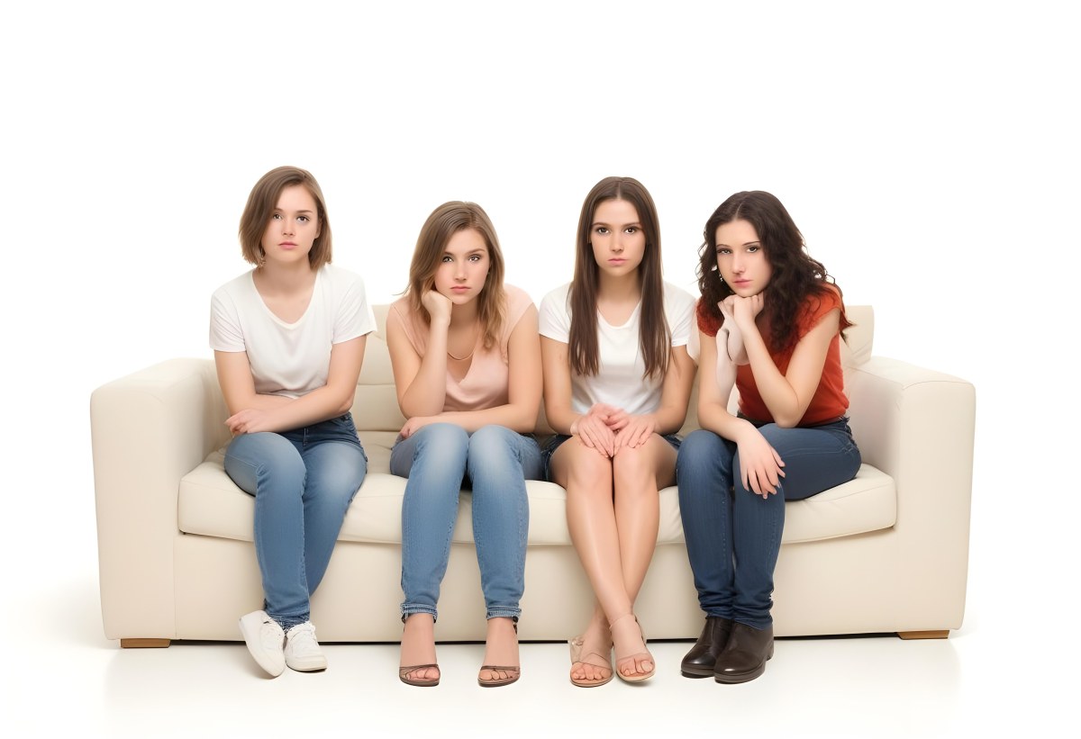 Four Young Caucasian Women Approximately 20 25 Years Old With Varying Hair Colors And Styles Long Sitting On A White Couch And Looking At The Camera 7 7adb