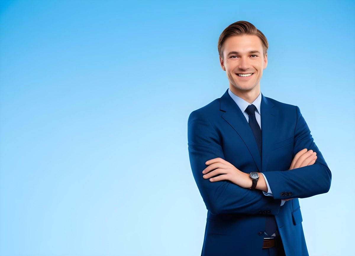 Minimal Soft Studio Light Photography Caucasian Male Approximately 30 Years Old With Light Brown Hair Wearing A Blue Suit And Tie Smiling With Arms Crossed Against A Light Blue Background High Detail Solid Bol 5 8a97