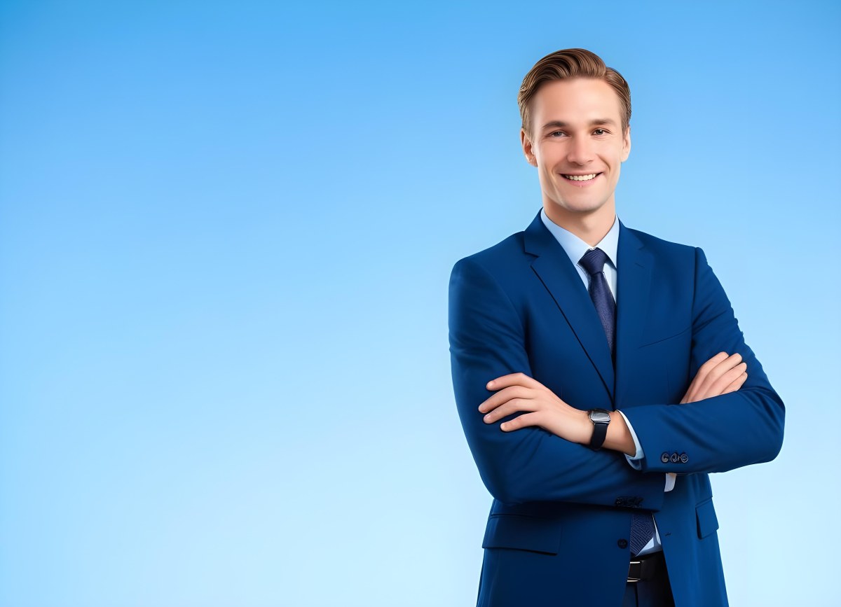 Minimal Soft Studio Light Photography Caucasian Male Approximately 30 Years Old With Light Brown Hair Wearing A Blue Suit And Tie Smiling With Arms Crossed Against A Light Blue Background High Detail Solid Bol 6 8f70