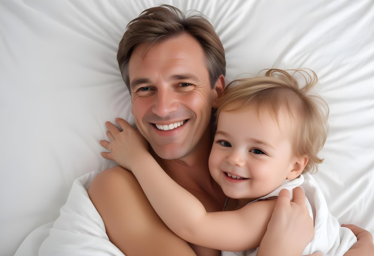 Young Caucasian Man With Short Blonde Hair And A Friendly Smile Holding A Young Blonde Toddler Girl Who Is Also Smiling In A Sunny Park 3 50da
