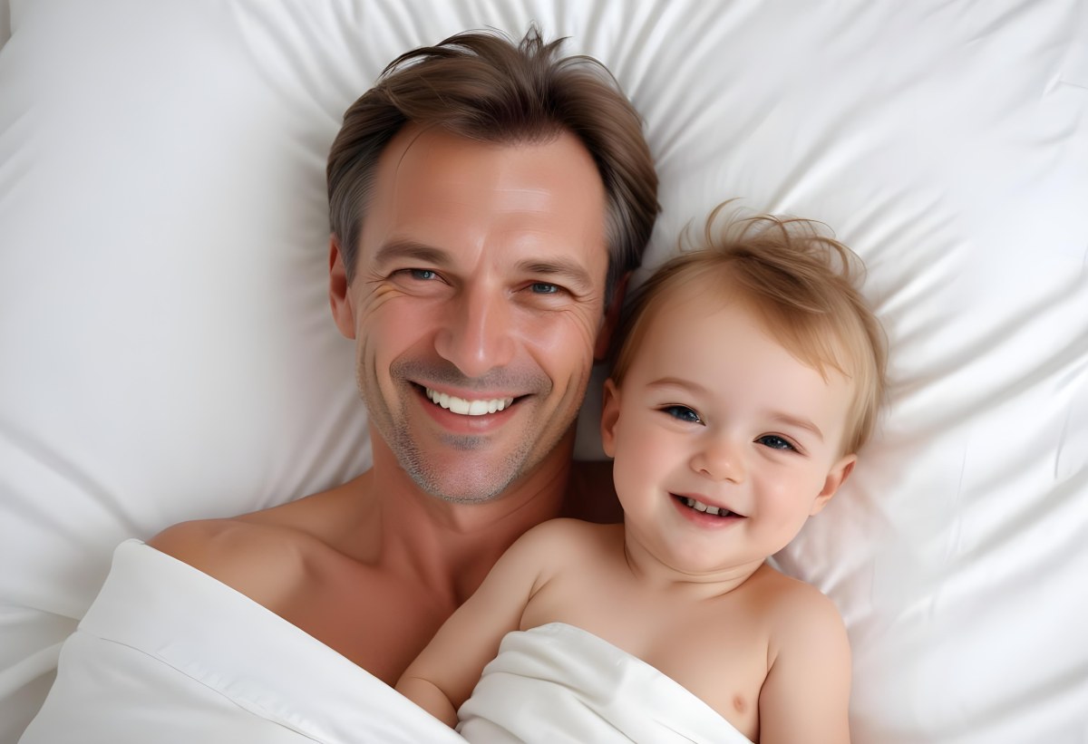 Young Caucasian Man With Short Blonde Hair And A Friendly Smile Holding A Young Blonde Toddler Girl Who Is Also Smiling In A Sunny Park 4 F604