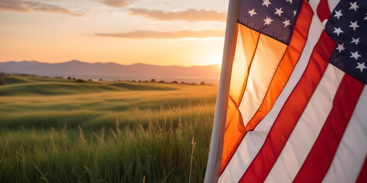 A Close Up View Of An American Flag Against A Scenic Sunset Landscape With A Grassy Field And A Bright Orange Sky 2 D032