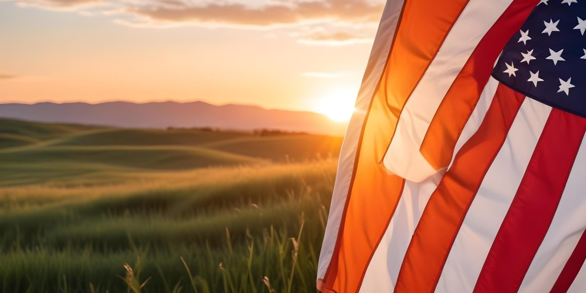 A Close Up View Of An American Flag Against A Scenic Sunset Landscape With A Grassy Field And A Bright Orange Sky 21 Fd31