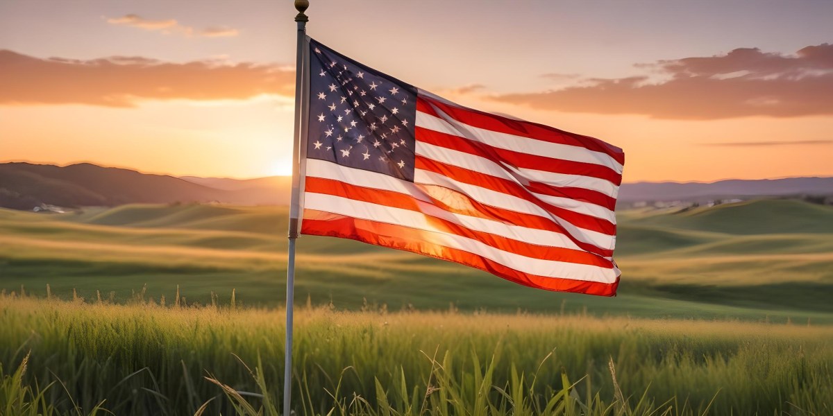 A Close Up View Of An American Flag Against A Scenic Sunset Landscape With A Grassy Field And A Bright Orange Sky 23 25bb