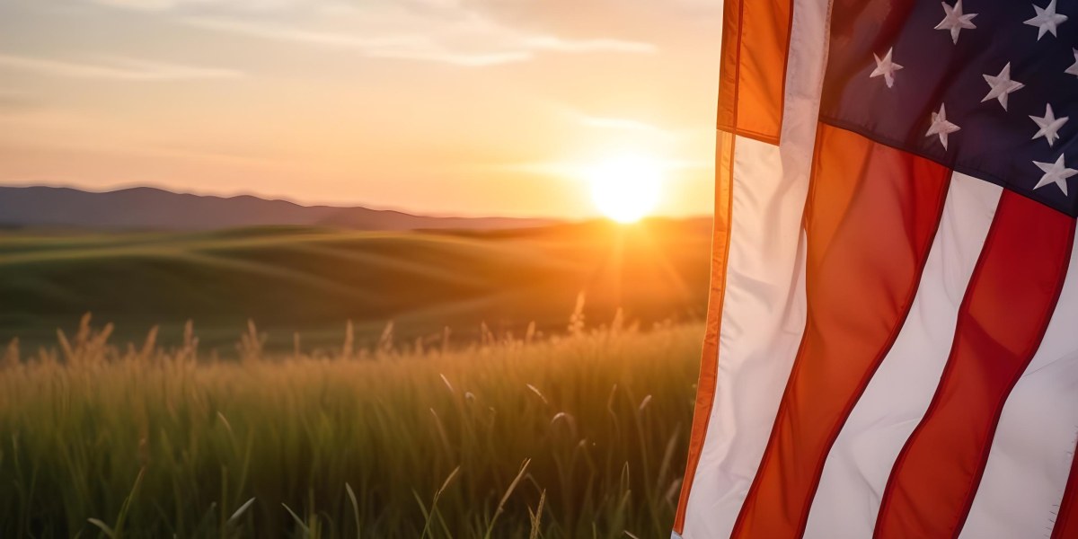 A Close Up View Of An American Flag Against A Scenic Sunset Landscape With A Grassy Field And A Bright Orange Sky 36 D429