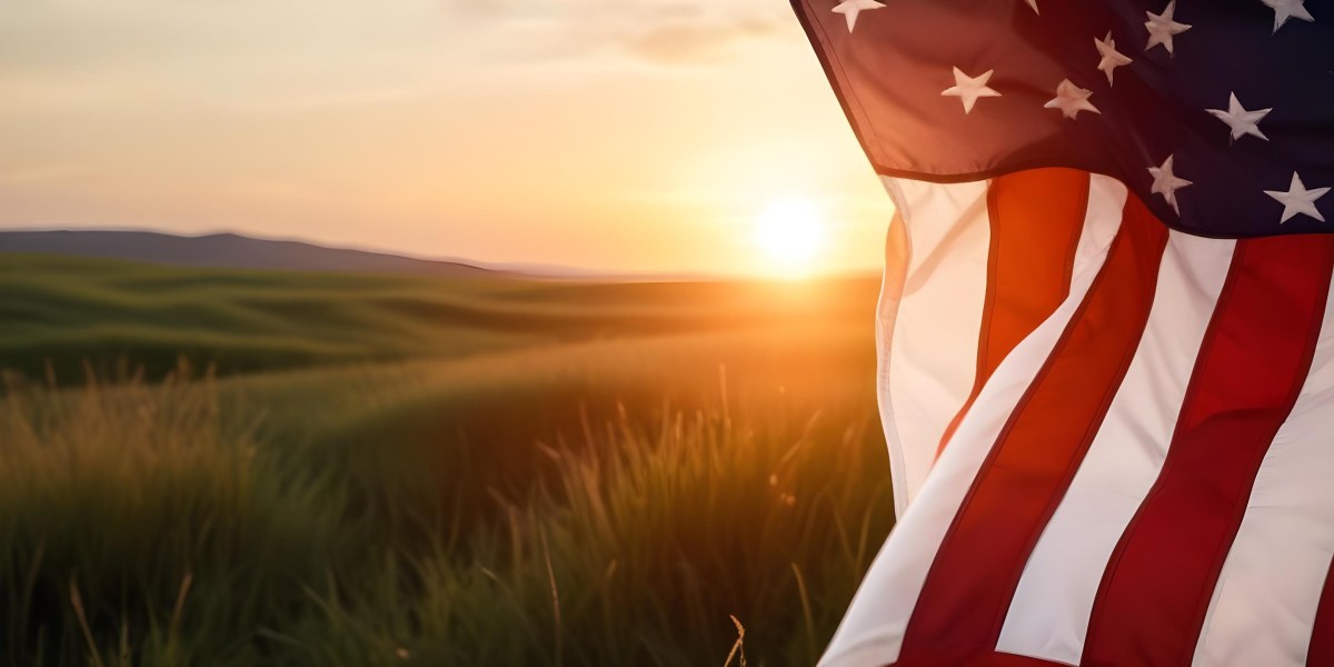 A Close Up View Of An American Flag Against A Scenic Sunset Landscape With A Grassy Field And A Bright Orange Sky 39 F504