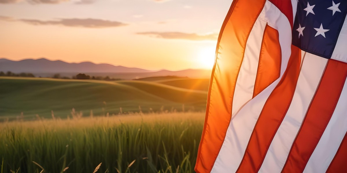 A Close Up View Of An American Flag Against A Scenic Sunset Landscape With A Grassy Field And A Bright Orange Sky 6 F3df