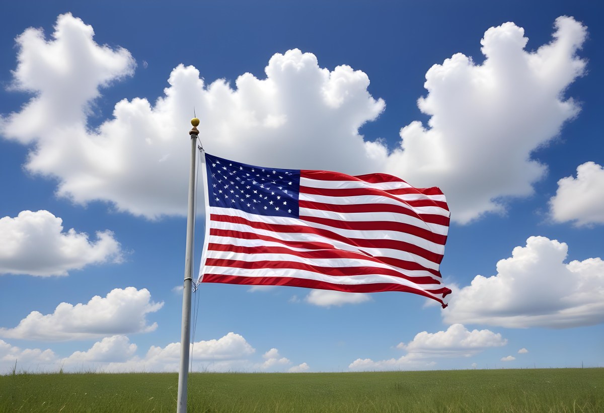 American Flag Waving In The Wind With Its Red And White Stripes And Blue Field Of Stars Against A Blue Sky With White Clouds 16 C94d