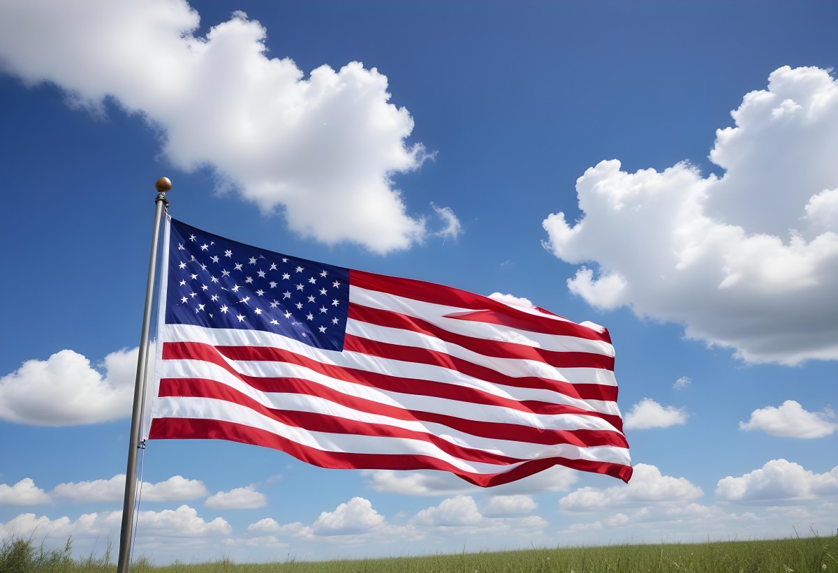 American Flag Waving In The Wind With Its Red And White Stripes And Blue Field Of Stars Against A Blue Sky With White Clouds 27 Cb95