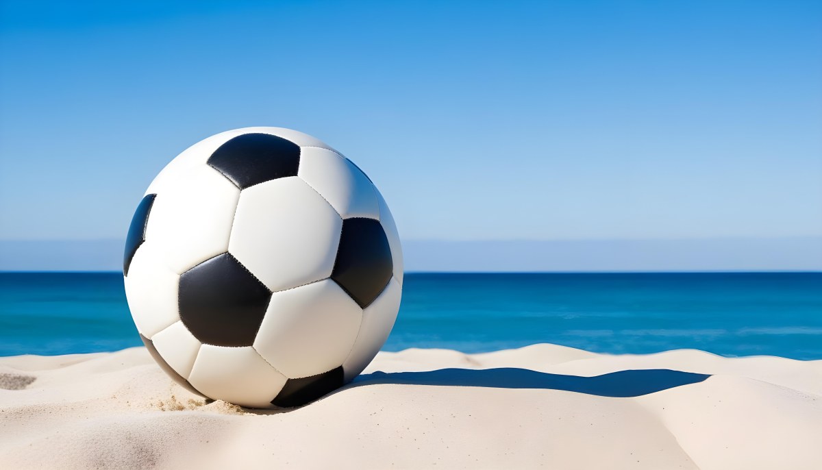 A Classic Black And White Soccer Ball On A Sandy Beach With A Clear Blue Sky And Ocean In The Background 10 B8c7