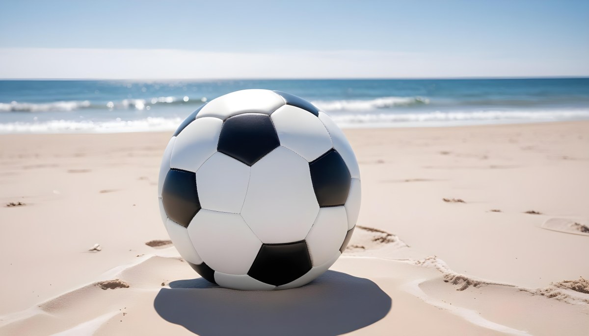 A Classic Black And White Soccer Ball On A Sandy Beach With A Clear Blue Sky And Ocean In The Background 13 39d0