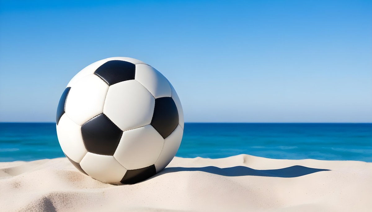 A Classic Black And White Soccer Ball On A Sandy Beach With A Clear Blue Sky And Ocean In The Background 15 5782