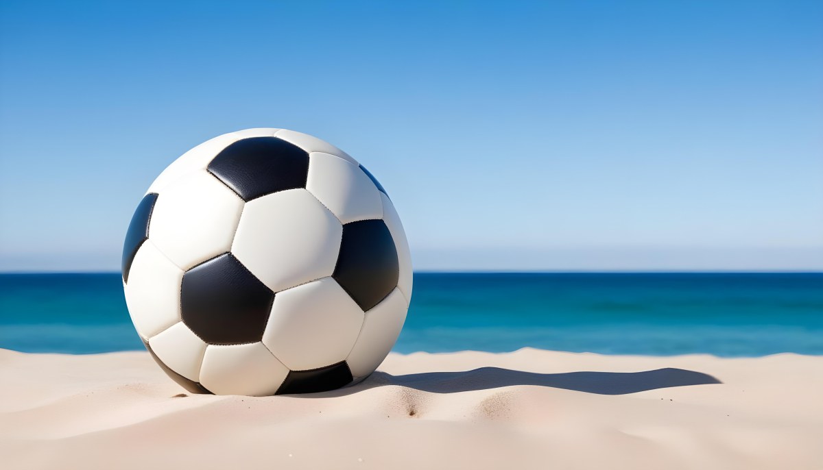A Classic Black And White Soccer Ball On A Sandy Beach With A Clear Blue Sky And Ocean In The Background 5 124c