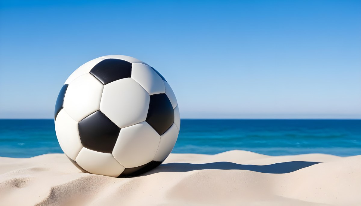 A Classic Black And White Soccer Ball On A Sandy Beach With A Clear Blue Sky And Ocean In The Background 7 3c28