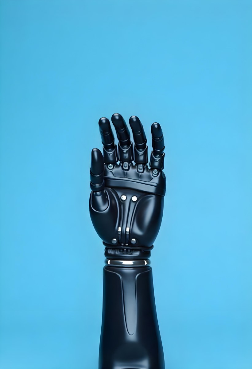 A Black Robotic Hand With Metallic Details Palm Facing Forward Fingers Slightly Curled Against A Solid Light Blue Background 13 4c94