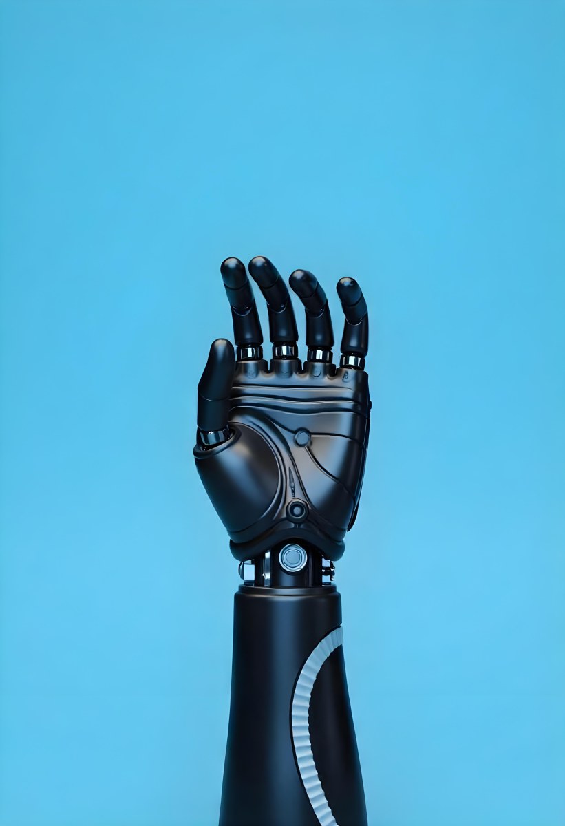 A Black Robotic Hand With Metallic Details Palm Facing Forward Fingers Slightly Curled Against A Solid Light Blue Background 18 B526